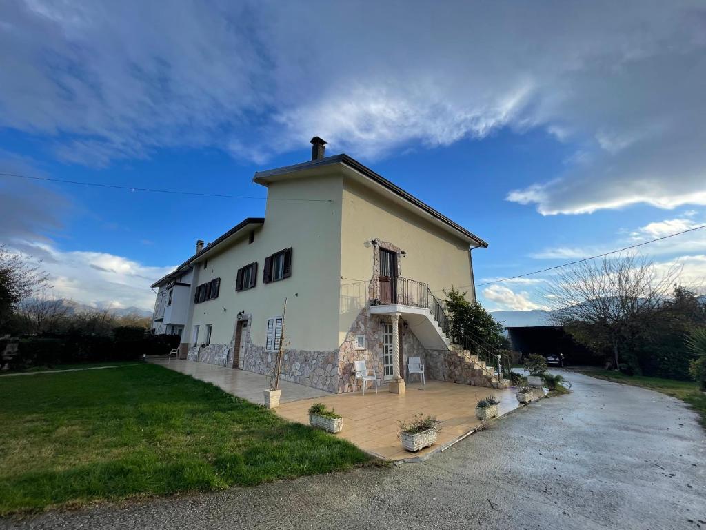 a large white building with a porch on a street at P&P nella natura in Cassino
