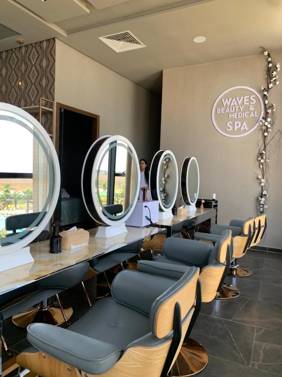 a salon with a row of mirrors on the wall at Waves Aqua Resort in Kenitra