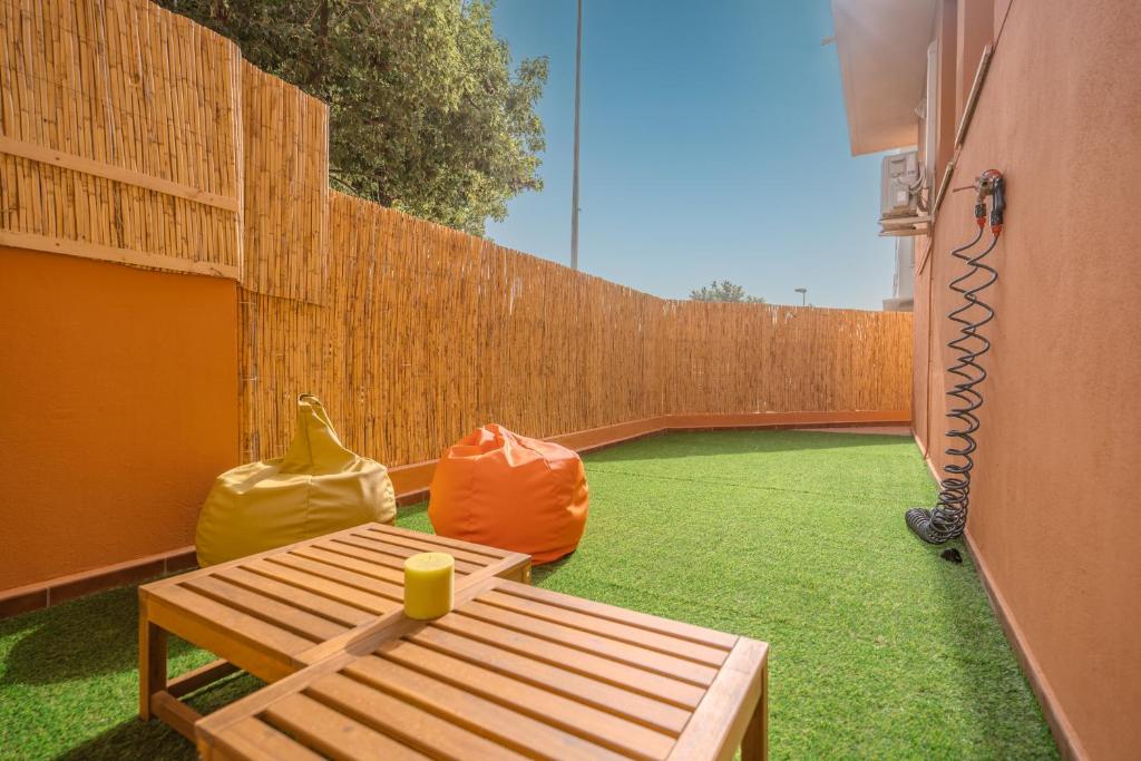 a patio with a wooden fence and a wooden table at Rooms City in San Isidro