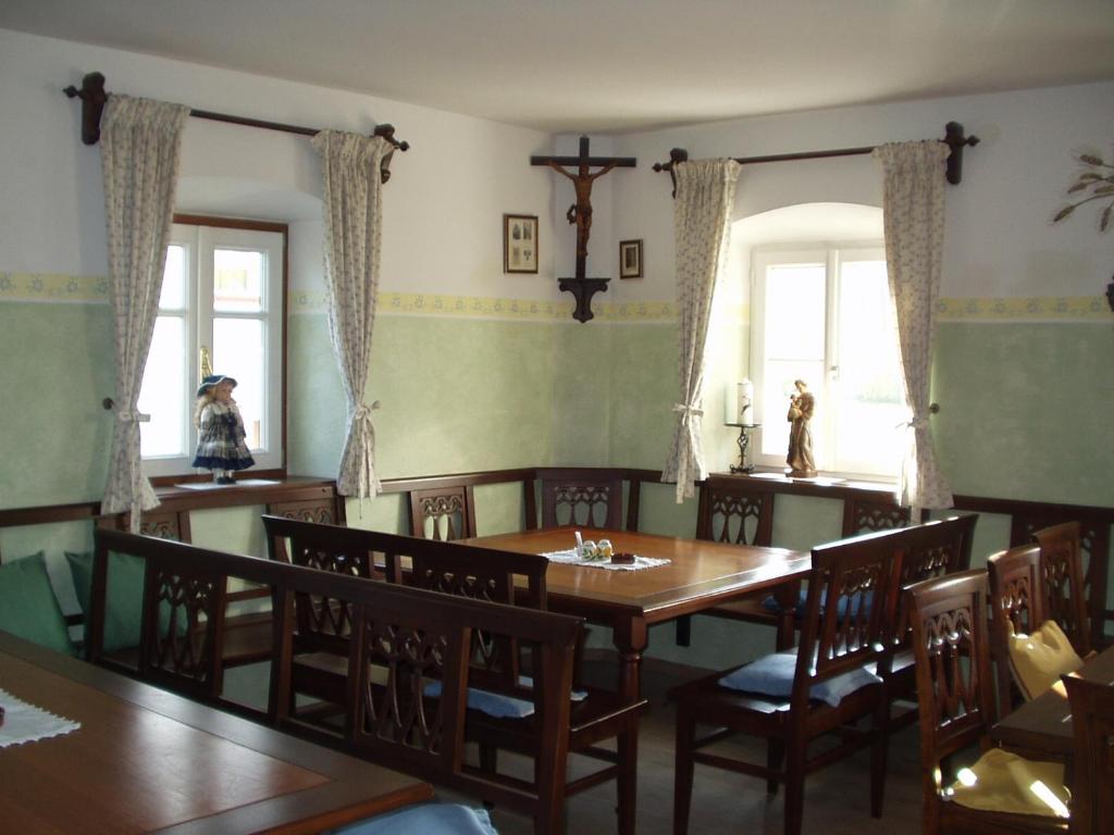 a dining room with a wooden table and chairs at Erlachmühle in Mondsee