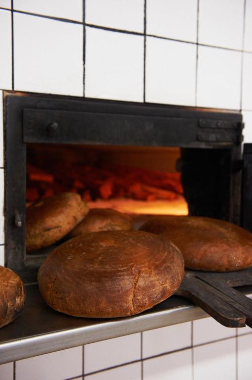 two loaves of bread are coming out of an oven at Erlachmühle in Mondsee