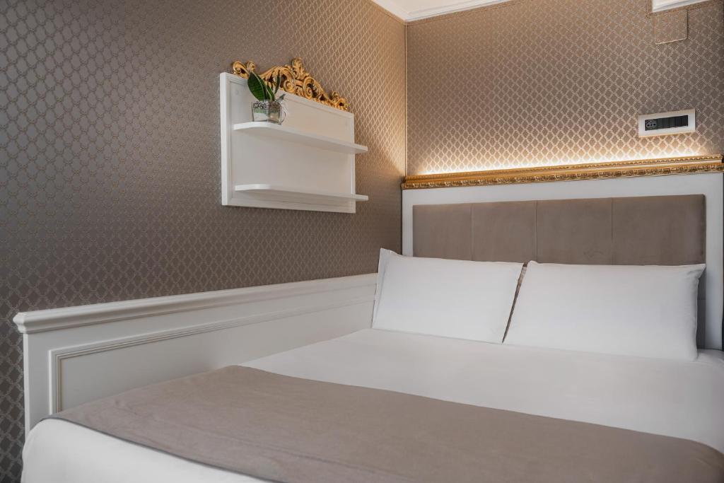 Postel nebo postele na pokoji v ubytování Hotel Montecarlo