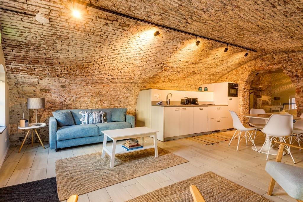 a living room with a blue couch and a table at Luxurious canal apartment in Utrecht A Location in Utrecht