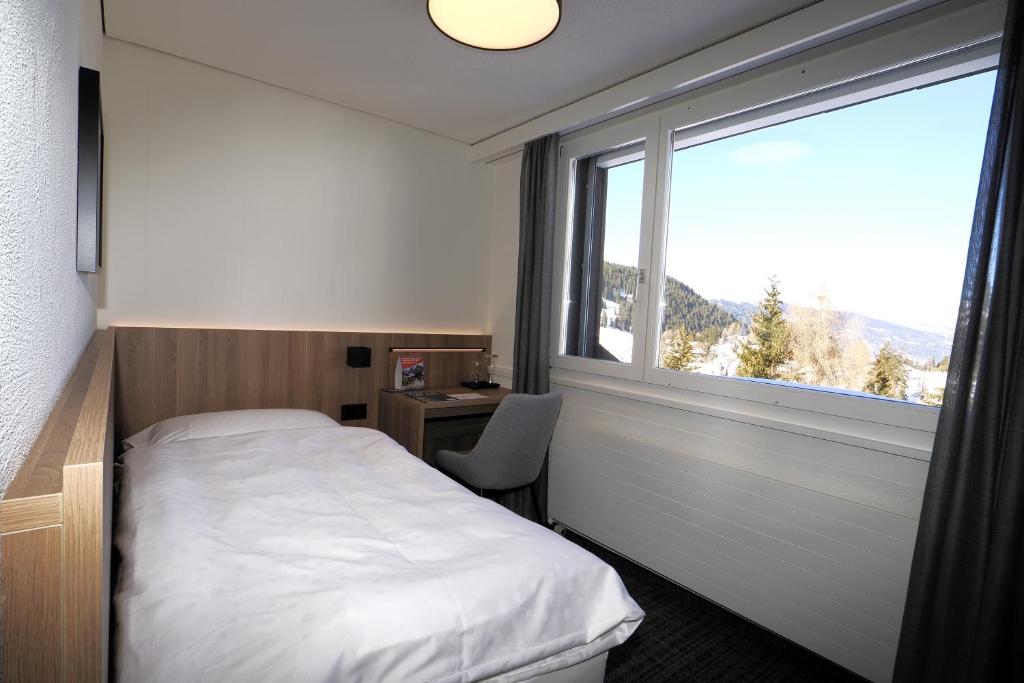 Postel nebo postele na pokoji v ubytování Hotel Alpina Parpan