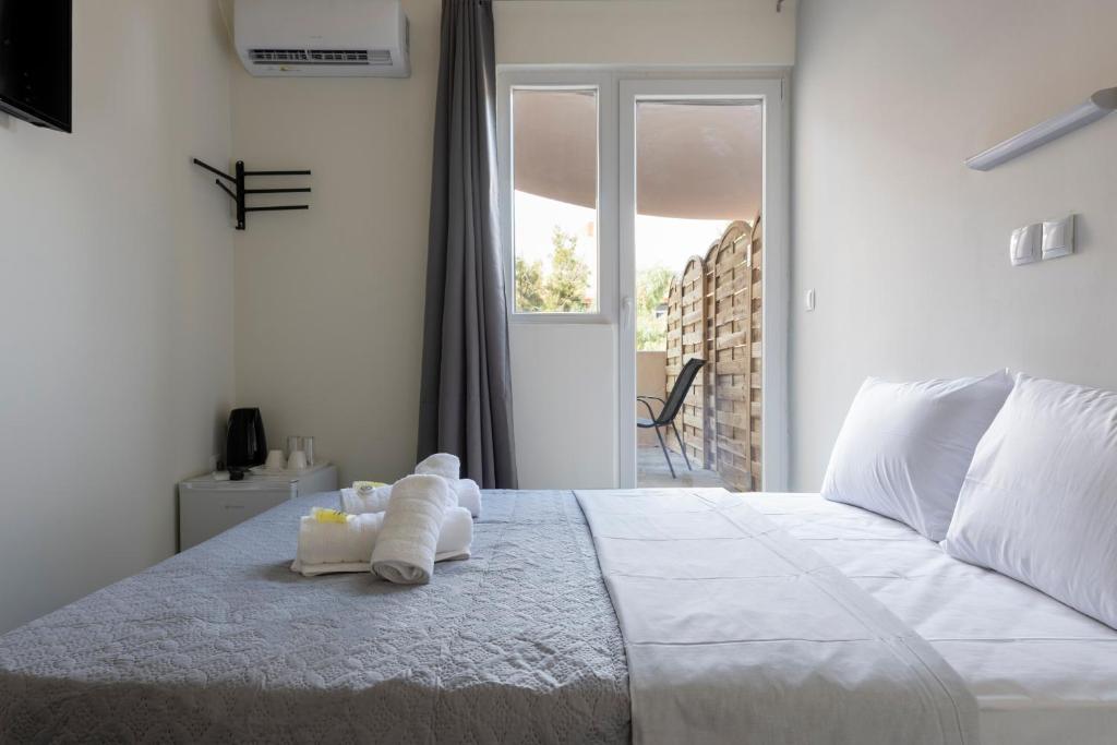 Postel nebo postele na pokoji v ubytování Liberal Mini Rooms & Suites
