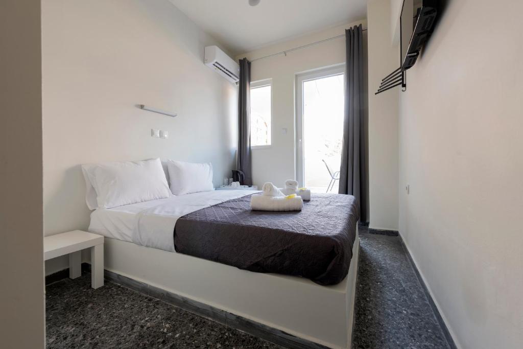 Postel nebo postele na pokoji v ubytování Liberal Mini Rooms & Suites