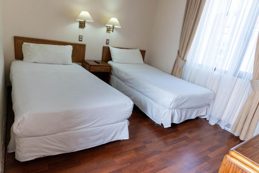 Postel nebo postele na pokoji v ubytování Hotel Francisco De Aguirre