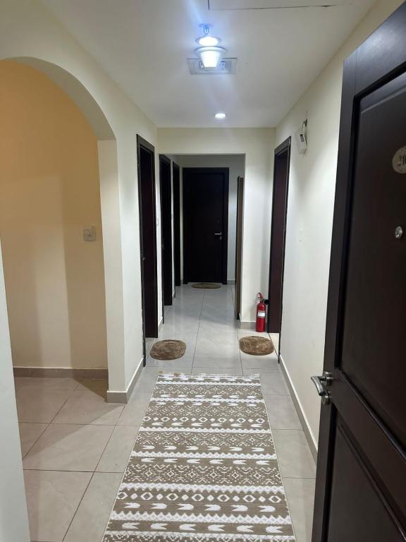 a hallway with rugs on the floor of a building at Spacious 3BR PLUS MAID ROOM in Sharjah