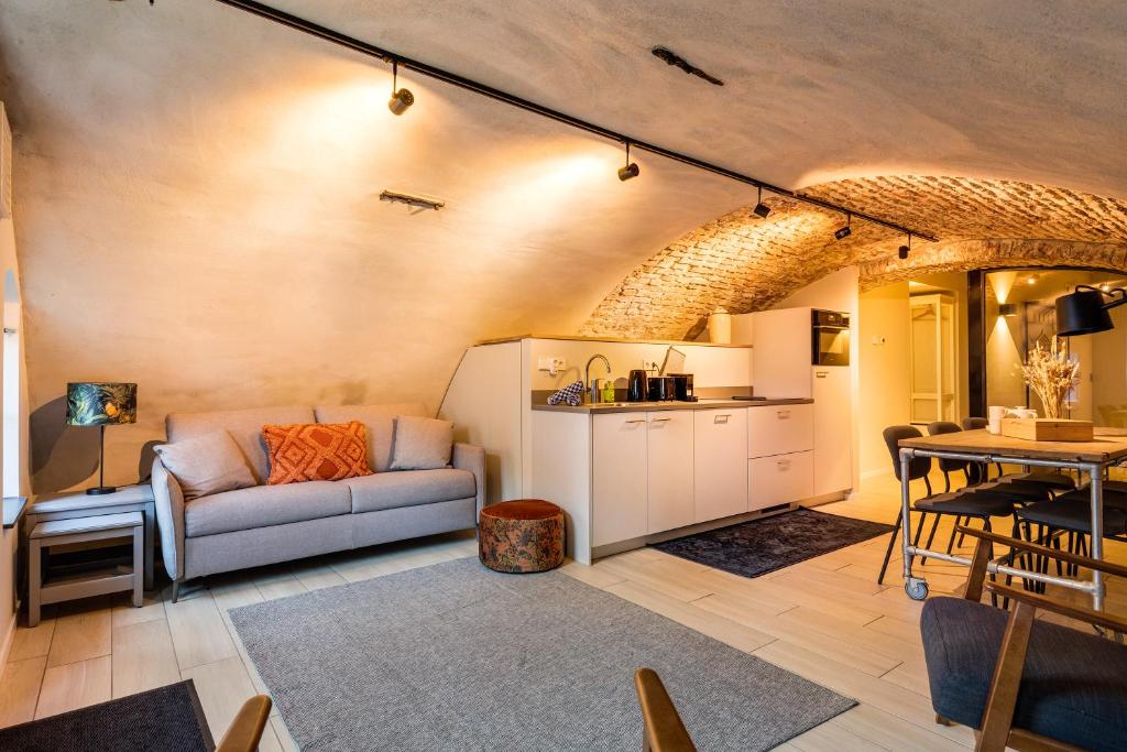 a living room with a couch and a table at 4P Unique canal apartment A Location in Utrecht in Utrecht