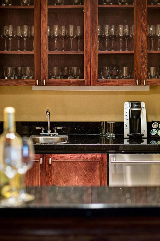 a kitchen with a sink and a coffee maker at Renaissance Mobile Riverview Plaza Hotel in Mobile