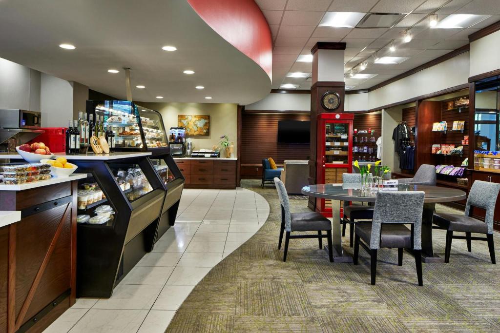 a restaurant with a table and a dining room at Renaissance Mobile Riverview Plaza Hotel in Mobile