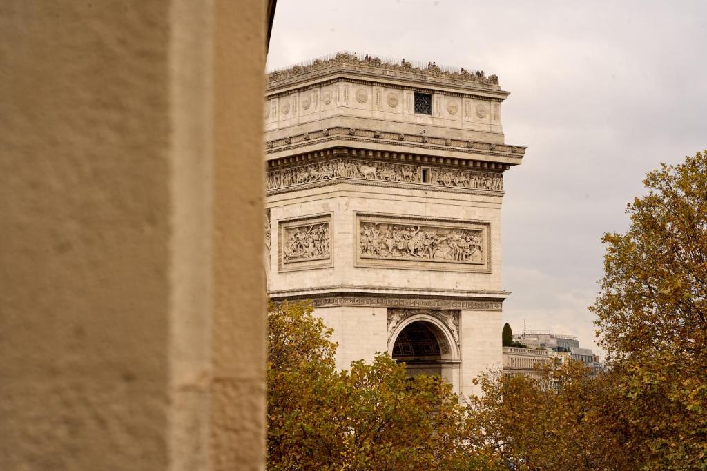 a tall white tower with a clock on it at 6 VH Hotel in Paris