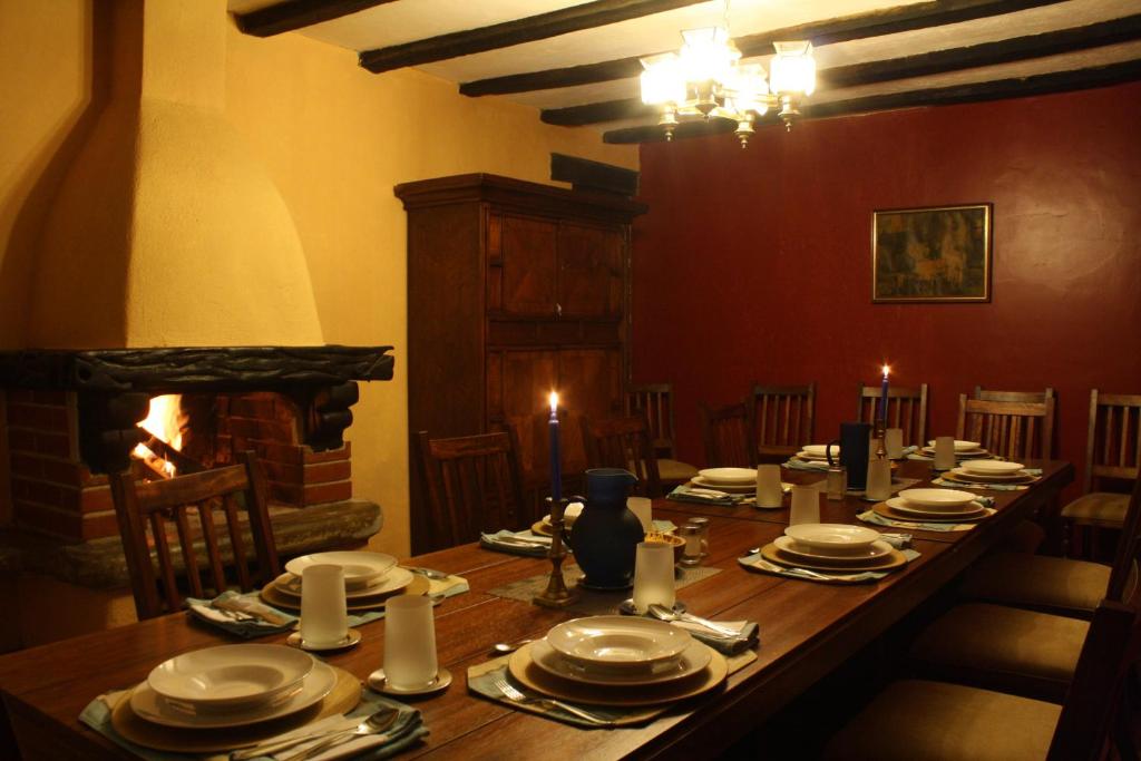 a dining room with a long table and a fireplace at Hacienda La Merced Baja in Hacienda Zuleta