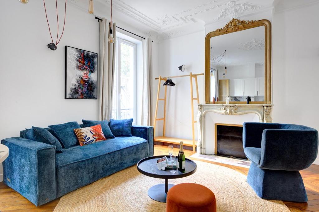 un salon avec un canapé bleu et un miroir dans l'établissement Bluestay 125 - Superb apartment in Paris, à Paris
