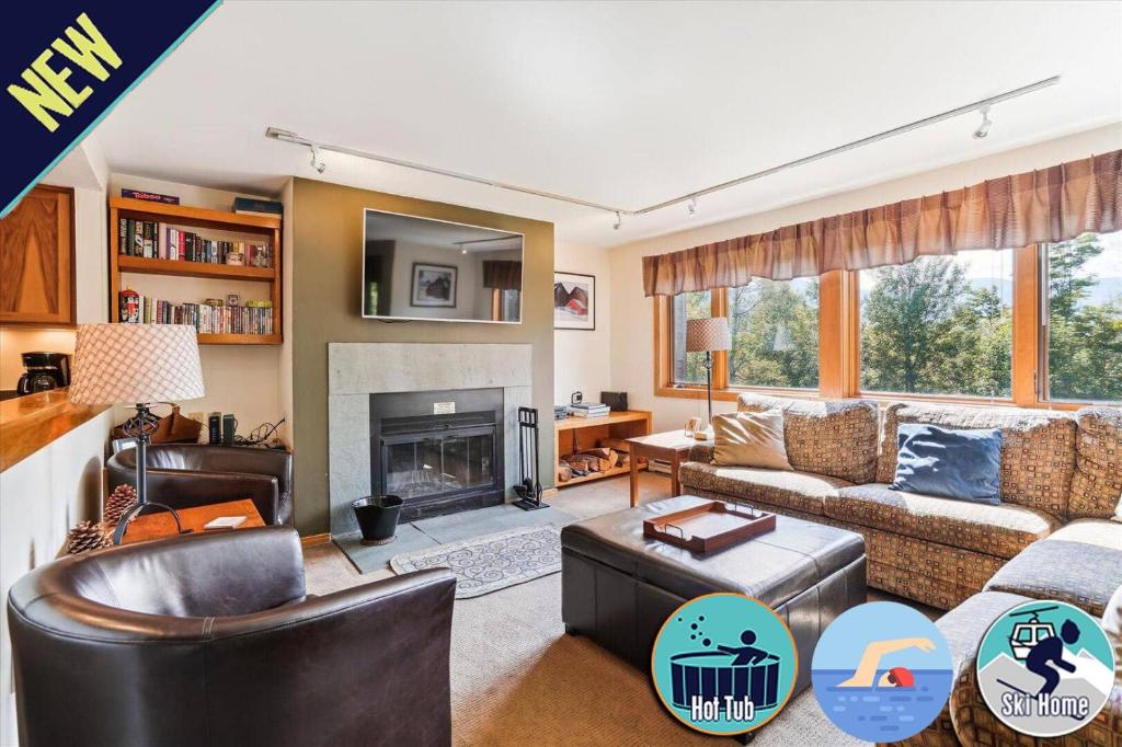 a living room with a couch and a fireplace at Highridge A16 Stunning Three Bedroom Condo with Whirlpool Bath, Heated Pool, and Game Room in Killington