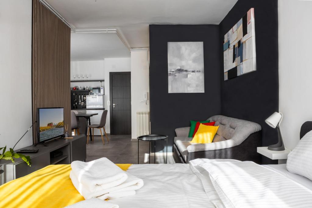 a bedroom with a bed and a living room at Studio Piaf City Break Nest in Belgrade