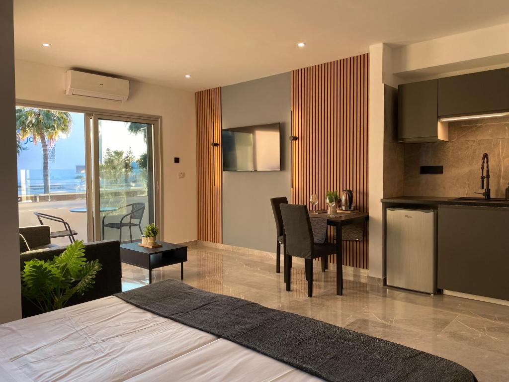 a bedroom with a kitchen and a dining room at Nissi Avenue Studios in Ayia Napa