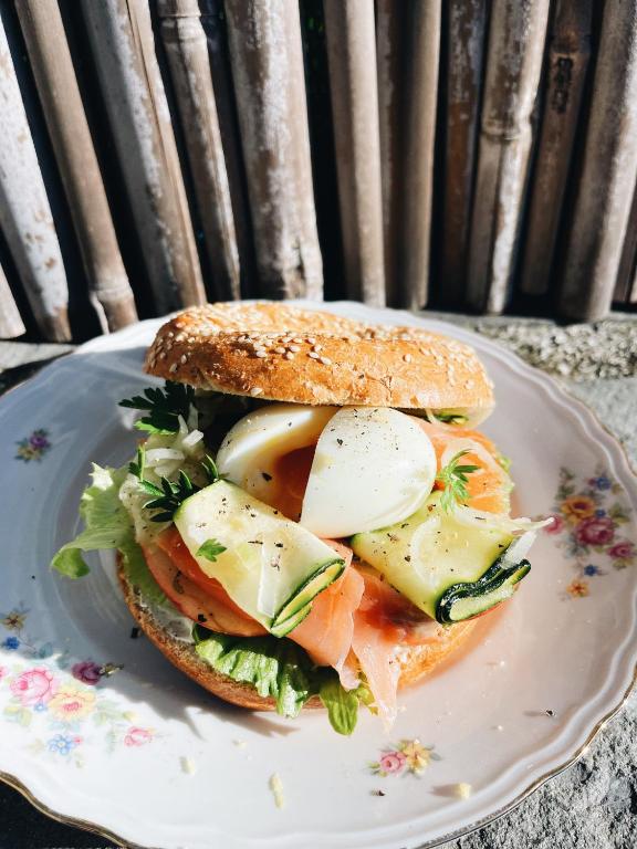 a sandwich on a white plate on a table at Locanda Il Carugio in Corniglia