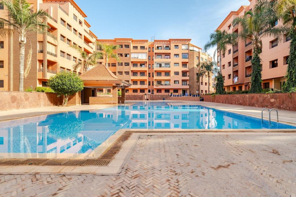 a large swimming pool in the middle of a building at la cocon paisible de Marrakech in Marrakech