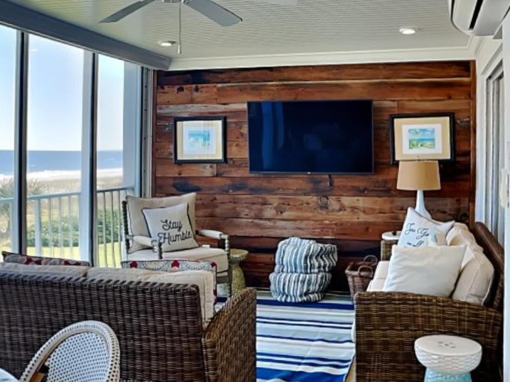 a living room with a television on a wall at Ponte Vedra Ocean Manor 106-D in Ponte Vedra