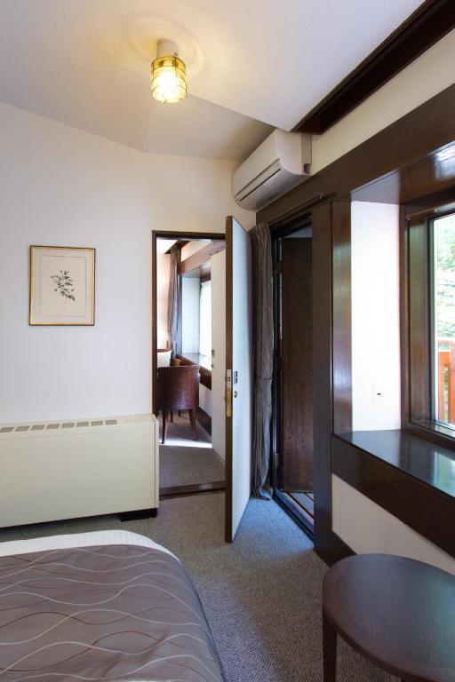 Postel nebo postele na pokoji v ubytování Yatsugatake Kogen Lodge