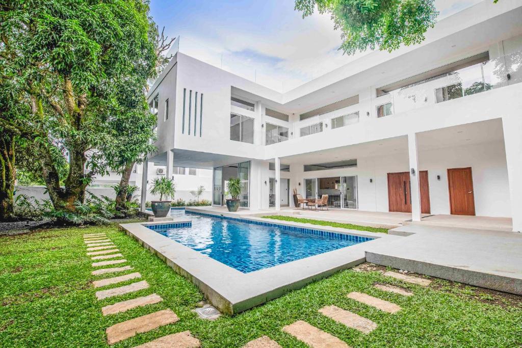 an exterior view of a house with a swimming pool at Corner House in Tagaytay