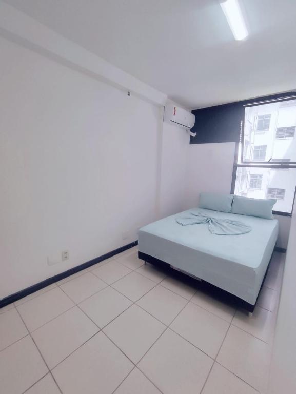 a white room with a bed and a window at Hostel Princess Copacabana in Rio de Janeiro