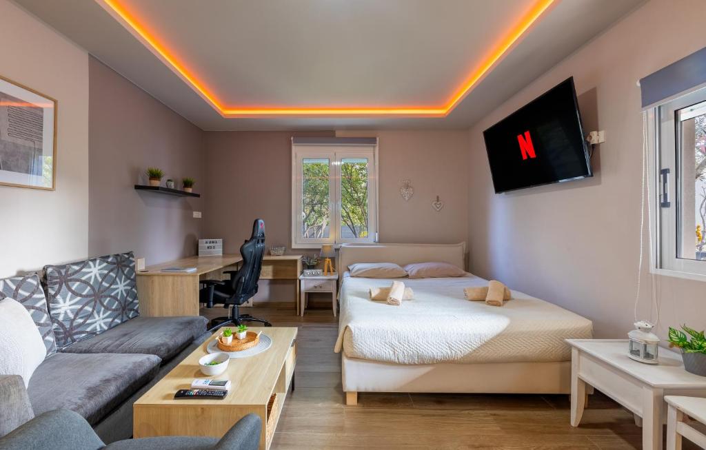 a living room with two beds and a couch at Hot Tub - 5 min to Beaches - Private Garden - Netflix in Lampi