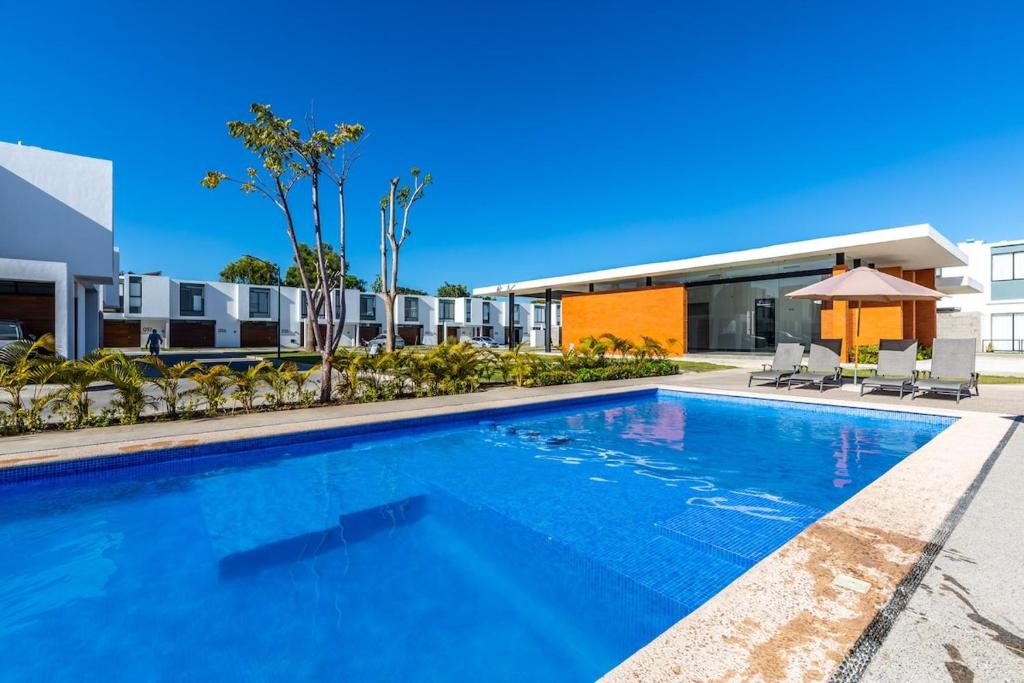 a swimming pool in front of a building at Ebano Residential in Las Juntas
