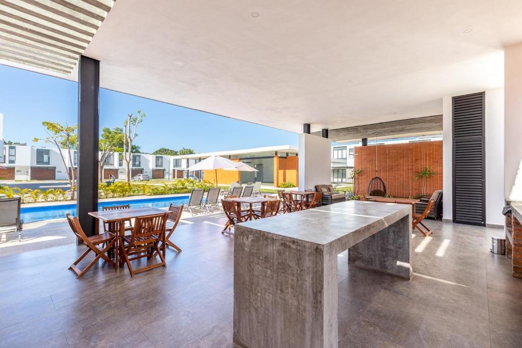 a living room with a table and chairs and a pool at Ebano Residential in Las Juntas