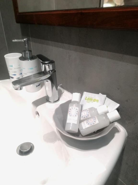 a bathroom sink with three remote controls on it at Casa Gimaga in Pozzuoli
