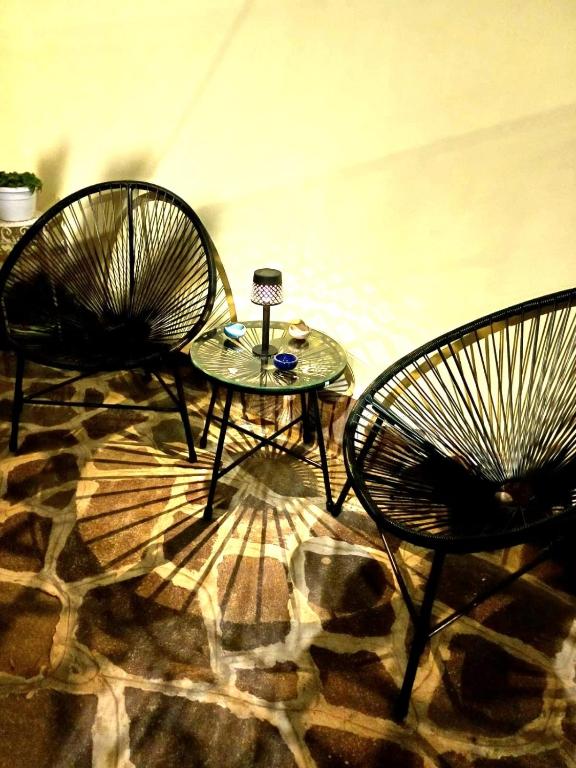 two chairs and a table in a room at Casa Gimaga in Pozzuoli