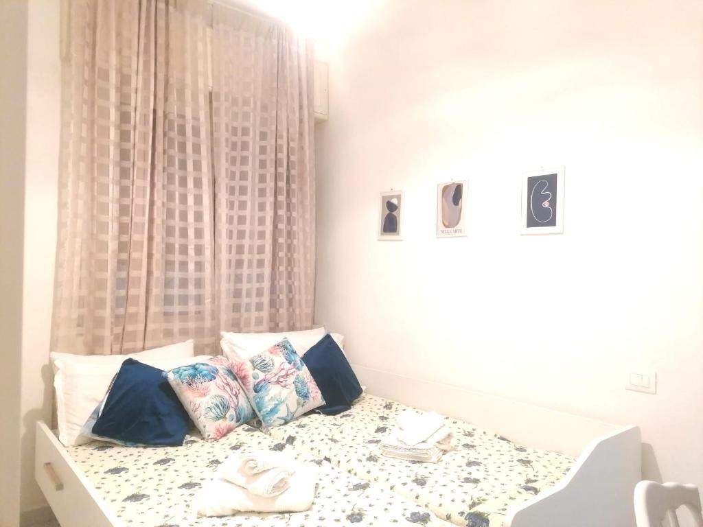 a room with a bed with a table and pillows at Casa Gimaga in Pozzuoli