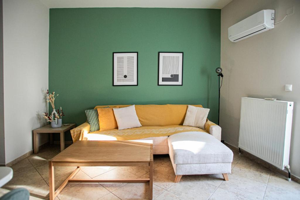 a living room with a couch and a table at Ariadnes cosy apartment- walk everywhere in Alexandroupoli