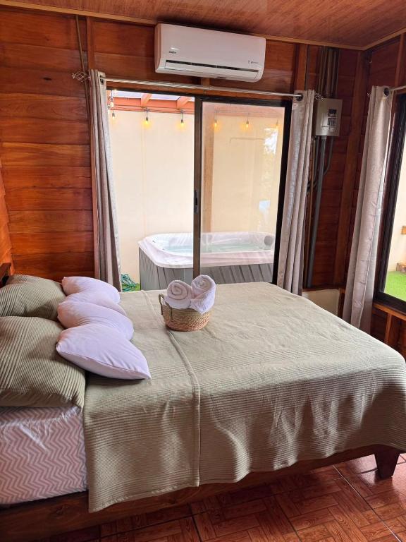 a bedroom with a bed with a basket on it at Vista Lapas Cottage in Guayabal