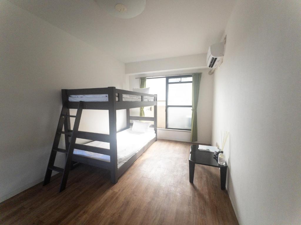 a room with a bunk bed in the corner of a room at HARMONY HOTEL Urawa - Vacation STAY 18305 in Saitama
