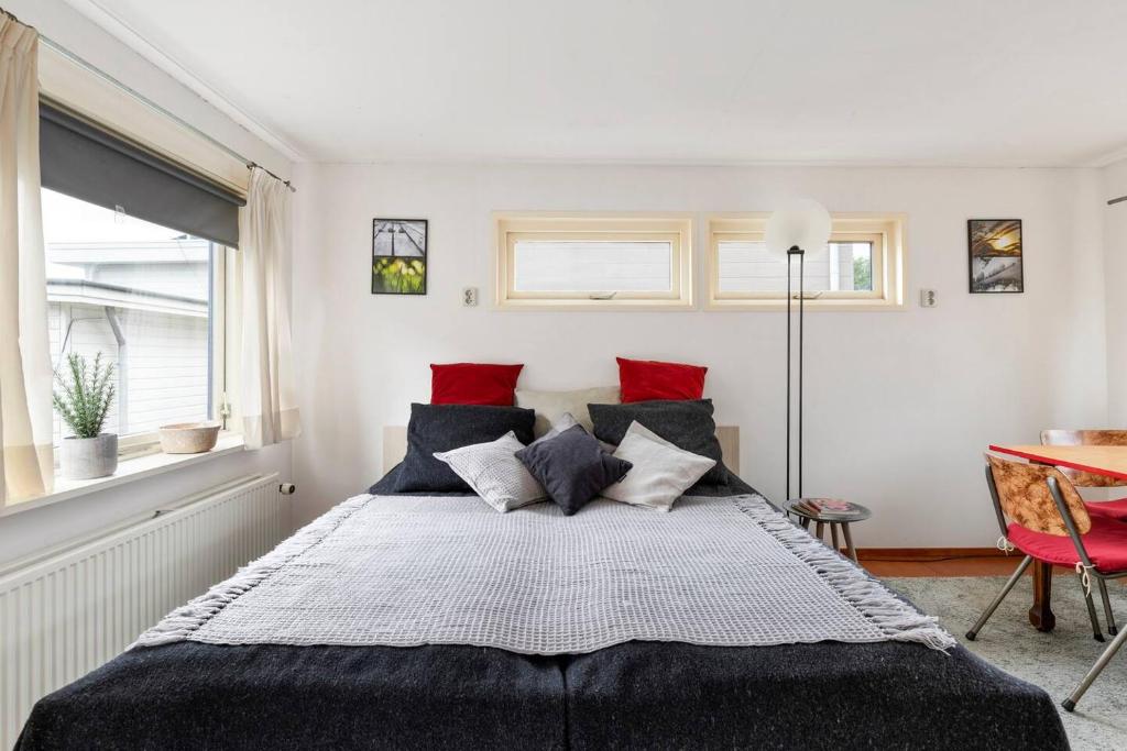 a bedroom with a large bed with red pillows at Authentic Dutch Houseboat in Amsterdam Zuid in Amsterdam