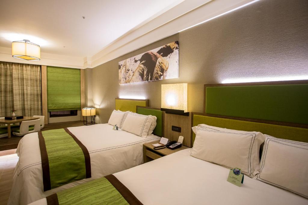 Postel nebo postele na pokoji v ubytování Fullon Hotel Fulong