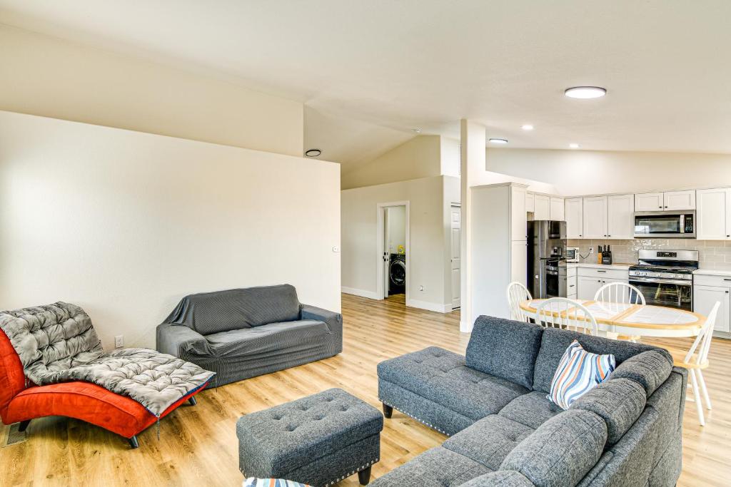 a living room with two couches and a table at 1 Mi to Pioneer Crossing Casino Fernley Retreat! in Fernley