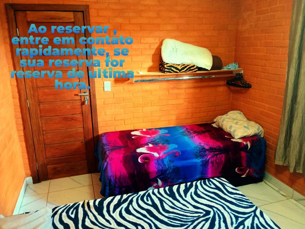 a room with a couch sitting next to a brick wall at Apartamento em GV in Governador Valadares