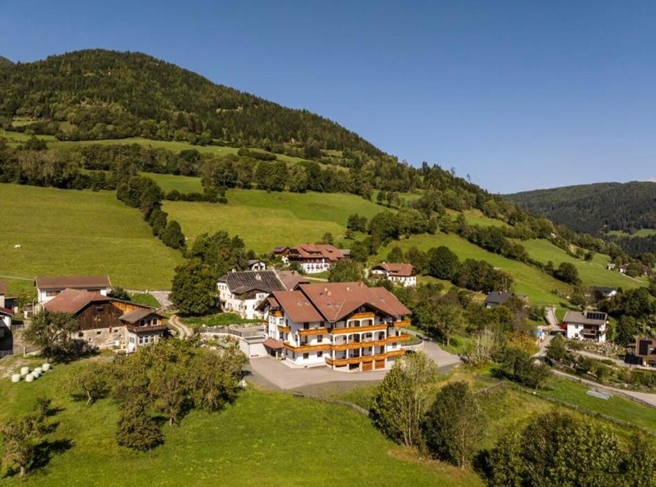 a large house in the middle of a green hill at Zlattinger in Trebesing