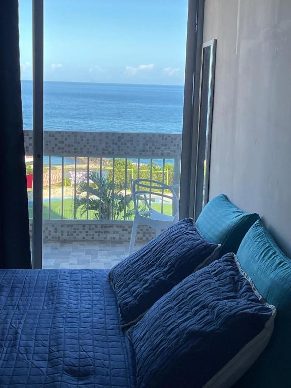 a bedroom with a bed with a view of the ocean at Apartamento VistaMar in La Guaira