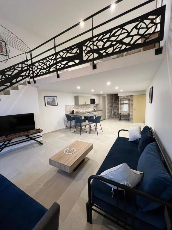 un salon avec un canapé bleu et une table dans l'établissement Appartement les orangers MENTON, à Menton