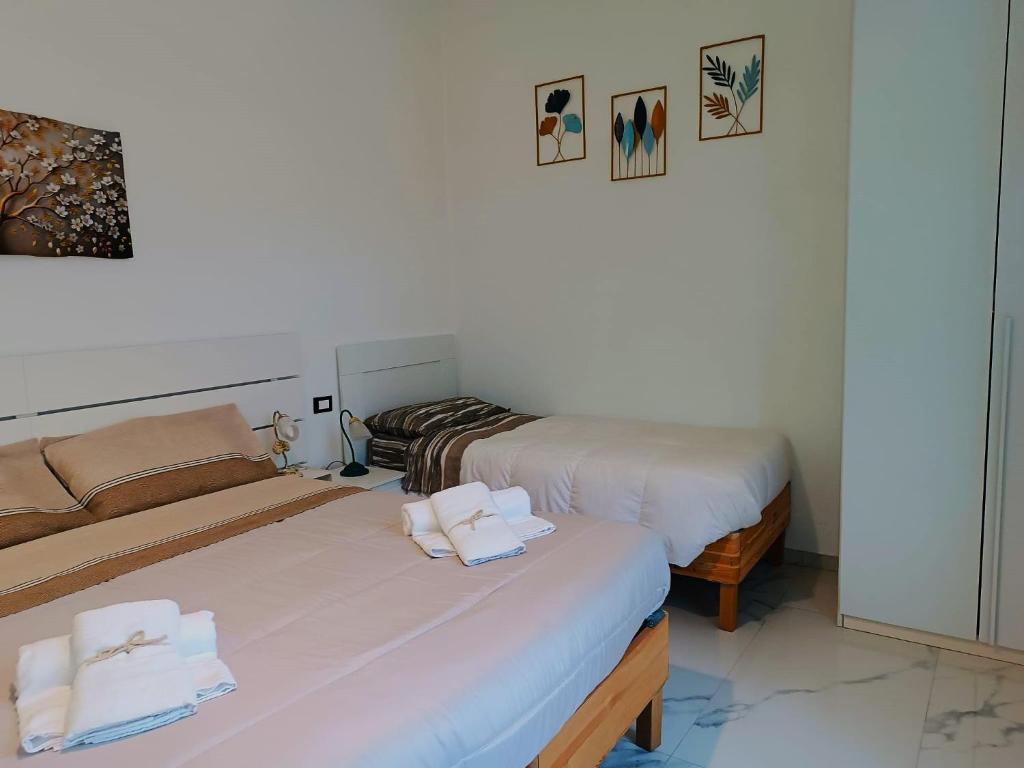 una camera con due letti con asciugamani di B&B Dream Inn a Pisa