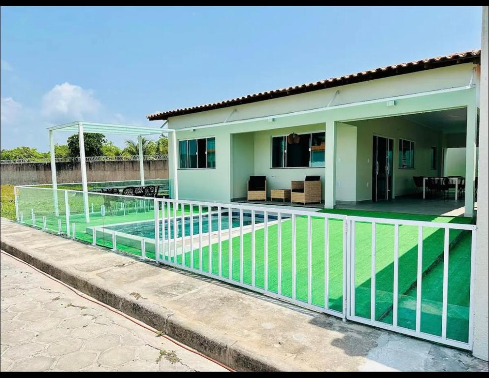 a house with a swimming pool in front of it at casa por temporada em santo amaro do maranhão in Santo Amaro