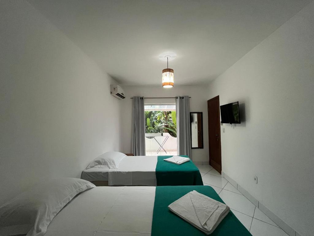 Postel nebo postele na pokoji v ubytování D'Ajuda Inn