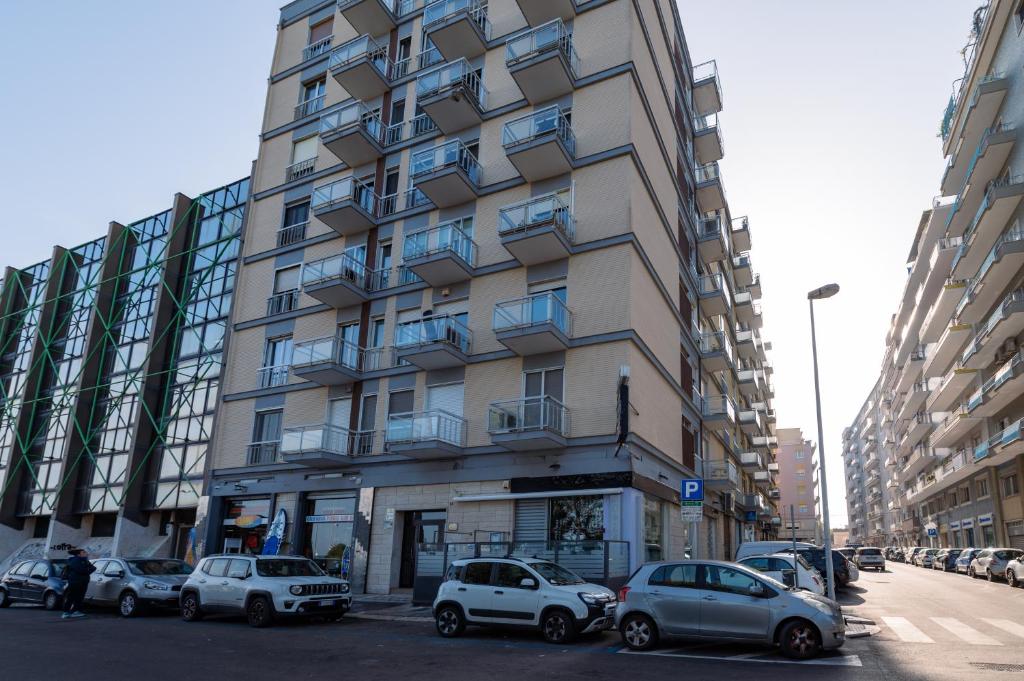 a tall building with cars parked in front of it at RosAmar in Bari