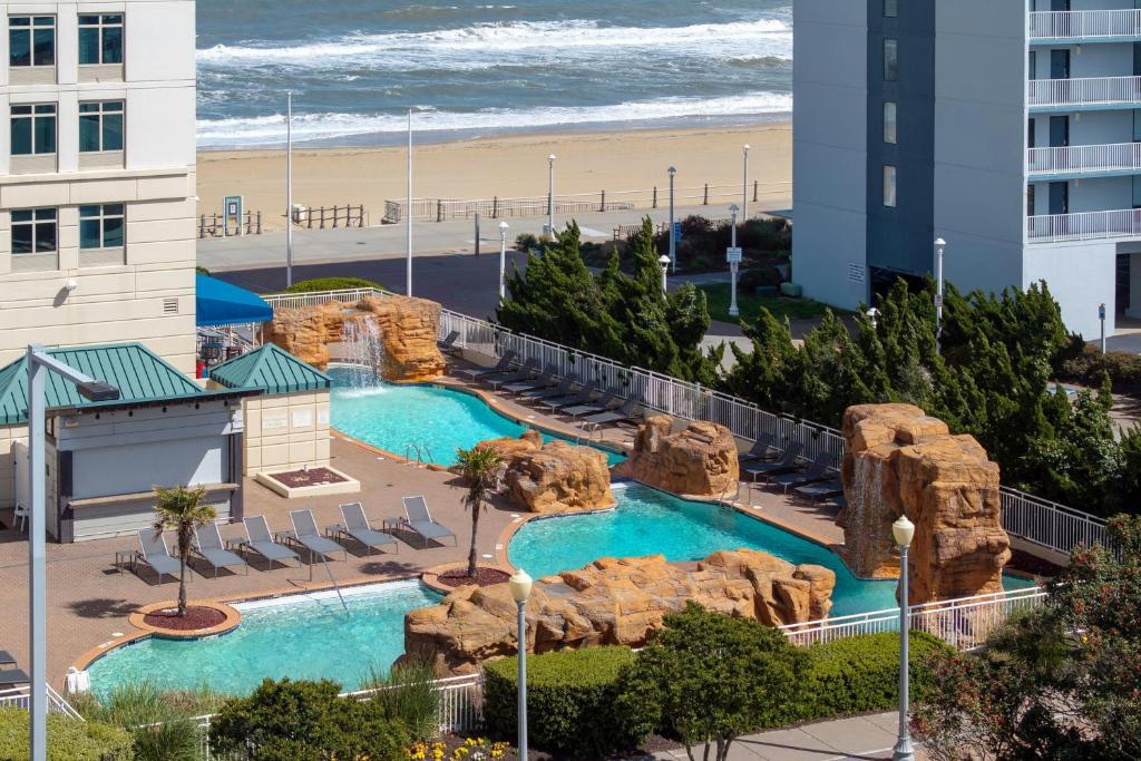 a view of the pool at the resort with the beach at Courtyard Virginia Beach Oceanfront / North 37th Street in Virginia Beach