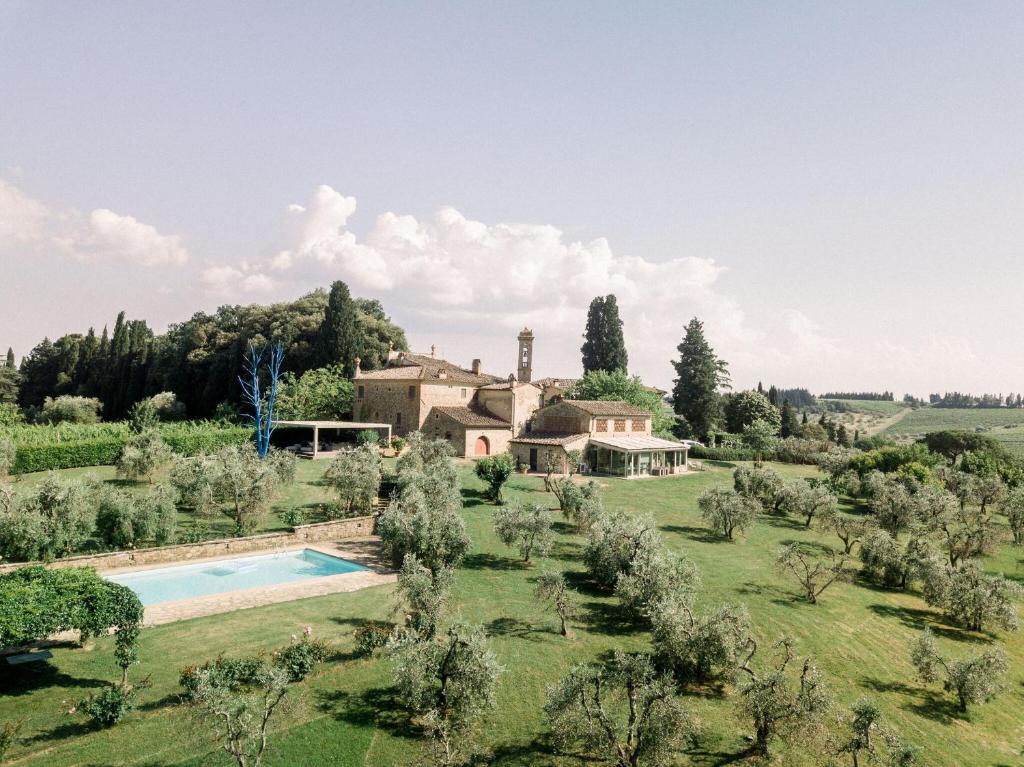 an estate with a swimming pool in the middle of a field at Villa Serena in Marcialla