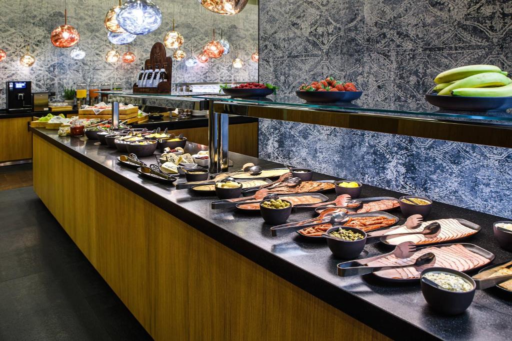 a buffet line with a lot of food on it at Courtyard by Marriott Warsaw Airport in Warsaw